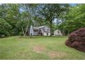 Beautifully landscaped property with a charming two-story home and a large, grassy yard at 127 Stagecoach Trl, Stockbridge, GA 30281