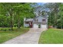 Inviting two-story home with a spacious driveway and mature trees at 127 Stagecoach Trl, Stockbridge, GA 30281
