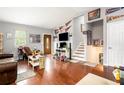 Cozy living room with hardwood floors, a staircase, and plenty of natural light at 6450 Ivey Se Rd, Mableton, GA 30126
