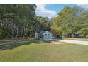 Beautiful single story home with a green lawn and plenty of surrounding trees at 45 Park Place Dr, Covington, GA 30016