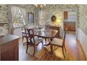 A traditionally styled dining room with hardwood floors and decorative wallpaper at 491 Princeton Ne Way, Atlanta, GA 30307