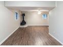 Finished basement with decorative fireplace, wood-look floors, and recessed lighting at 5802 Oakleaf Dr, Stone Mountain, GA 30087