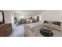 Spacious living room featuring modern furniture, an open floor plan, and seamless access to the kitchen and dining area at 175 Silverton Dr, Dacula, GA 30019