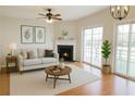 Bright living room featuring a fireplace, ceiling fan, and sliding glass doors leading to the outdoors at 2263 Leicester Se Way, Atlanta, GA 30316