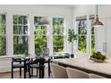 Bright breakfast nook featuring modern chairs and table with natural light streaming in from the large windows at 331 Peachtree Ne Ave, Atlanta, GA 30305