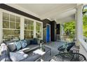 Inviting front porch featuring a comfortable seating area, stylish decor, and a vibrant blue door at 331 Peachtree Ne Ave, Atlanta, GA 30305