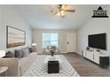 Bright living room with modern decor, natural light and hardwood floors at 8051 Trinity Park Dr, Riverdale, GA 30296