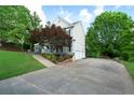 View of the side of the house featuring a long driveway leading to a two-car garage at 31 Clearview Dr, Cartersville, GA 30121