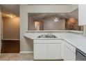 Kitchen featuring white countertops and cabinets with an open view to the living area and fireplace at 964 Chapman Ln, Stone Mountain, GA 30088