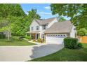 Attractive two-story home with a two-car garage, manicured lawn, complemented by stone accents and landscaping at 182 Garden Manor Ct, Loganville, GA 30052