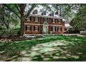 Charming brick home features a lush lawn and mature trees, offering a serene and inviting curb appeal at 2121 Ponce De Leon Ne Ave, Atlanta, GA 30307