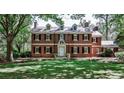 Traditional brick home with symmetrical design, complete with dormer windows and a well-maintained front lawn at 2121 Ponce De Leon Ne Ave, Atlanta, GA 30307