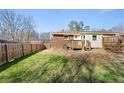A spacious backyard featuring a wooden deck and privacy fence at 2968 Cleburne Pkwy, Powder Springs, GA 30127