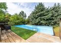 Backyard pool with wooden deck and privacy provided by mature trees at 3012 Keeneland Blvd, Mcdonough, GA 30252