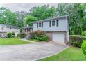 A well-maintained two-story home featuring a driveway and lush greenery, offering a welcoming curb appeal at 3664 Satellite Ter, Ellenwood, GA 30294