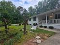 Landscaped front yard featuring cozy seating area and mature trees at 2799 Mockingbird Cir, Duluth, GA 30096