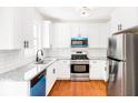 Beautiful kitchen featuring stainless steel appliances and sleek white cabinetry at 3022 Kentmere Dr, Cumming, GA 30040