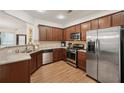 Well-equipped kitchen with stainless steel appliances, granite countertops, and wood cabinets at 4430 Cedar Bridge Walk, Suwanee, GA 30024