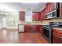 Well-appointed kitchen featuring cherry cabinets and stainless steel appliances at 535 Pierpoint Dr, Atlanta, GA 30331