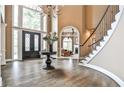 Grand foyer features soaring ceilings, hardwood floors, and statement staircase at 1114 Waterford Green Pt, Marietta, GA 30068