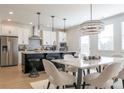 Modern eat-in kitchen with stainless steel appliances and a large island with bar stool seating at 1712 Fulmont Cir, Mableton, GA 30126