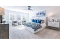 Spacious main bedroom with plush carpeting, large windows, and a comfortable bed at 1712 Fulmont Cir, Mableton, GA 30126