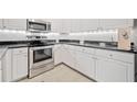 Well-lit kitchen with stainless steel oven, white cabinets, and modern appliances at 1850 Cotillion Dr # 3114, Atlanta, GA 30338