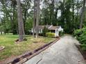 A picturesque view of a quaint home surrounded by lush greenery and tall trees at 1962 Clairmont Ter, Atlanta, GA 30345