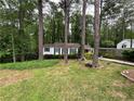 Inviting home exterior with a well-maintained lawn and mature trees providing shade at 1962 Clairmont Ter, Atlanta, GA 30345
