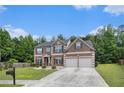 Beautiful brick home with a two-car garage and lush landscaping in a serene setting at 3225 Rex Ridge Dr, Rex, GA 30273