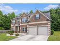 Attractive brick-front home with a two-car garage, neat landscaping and inviting curb appeal at 3225 Rex Ridge Dr, Rex, GA 30273