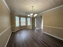 Elegant dining room featuring modern chandelier and vinyl flooring at 1822 Millwood Park Ct, Buford, GA 30518