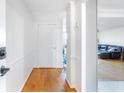 Bright hallway featuring hardwood floors, white walls, and crown molding, leading to living area at 2965 Pharr Court South Nw # 1-817, Atlanta, GA 30305