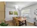 Bright dining room with a wooden table, stylish wicker chairs, and modern pendant lighting creating an inviting atmosphere at 3331 Doyle Sw Ln, Marietta, GA 30060