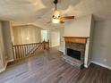 Inviting living room with hardwood floors, stone fireplace, and a staircase at 71 Streamview Trl, Douglasville, GA 30134