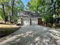 Detached two-car garage with a brick facade and concrete driveway at 894 Oak Rd, Lawrenceville, GA 30044