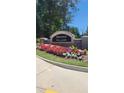 Brooks Village community entrance sign surrounded by colorful flowers on a sunny day at 1416 Clear Pond Ln, Dacula, GA 30019