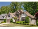 Well-maintained home featuring a landscaped yard and a charming exterior with stone and stucco at 150 Park Creek Dr, Alpharetta, GA 30005