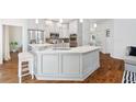 Bright kitchen with white cabinets, stainless steel appliances, and a large island with seating at 150 Park Creek Dr, Alpharetta, GA 30005