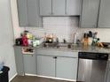 Efficient kitchen with stainless steel dishwasher, granite countertops, and gray cabinets at 3231 Abbeywood Dr, Decatur, GA 30034