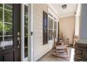 View of the inviting front porch with rocking chairs, offering a relaxing outdoor space at 6330 Beaver Crossing Dr, Cumming, GA 30040