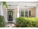 Charming covered front porch with classic columns and decorative shrubbery offers curb appeal at 6330 Beaver Crossing Dr, Cumming, GA 30040