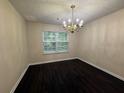 Dining room featuring a classic chandelier and laminate floors at 110 Slate Ridge Ln, Loganville, GA 30052