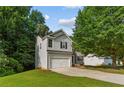 Beautiful two-story home boasts a two-car garage, stone accents, and a lovely landscaped front yard at 110 Slate Ridge Ln, Loganville, GA 30052