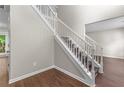 Foyer features beautiful wood flooring, a staircase with white railings, and a bright, open feel at 110 Slate Ridge Ln, Loganville, GA 30052