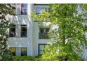 Close up view of a building's exterior, showcasing windows and balconies with lush foliage at 821 Ralph Mcgill Ne Blvd # 3325, Atlanta, GA 30306