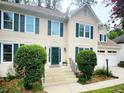 Inviting front entrance with a decorative front door, well-manicured bushes, and green shutters at 2980 Milford Sw Trl, Marietta, GA 30008