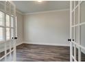 Home office with elegant French doors and hardwood floors provides a quiet workspace at 3890 Ivy Cottage Dr, Snellville, GA 30039