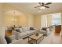 Bright living room with hardwood floors, neutral furniture, and an open layout to the dining area at 10462 Bent Tree Vw, Duluth, GA 30097