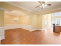 Bright and airy living room with hardwood floors and open layout to the kitchen and dining areas at 10462 Bent Tree Vw, Duluth, GA 30097